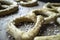 Raw pretzels with coarse salt are placed on a metal tray and are ready for baking in the oven. Traditional food. Oktoberfest