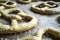 Raw pretzels with coarse salt are placed on a metal tray and are ready for baking in the oven. Traditional food. Oktoberfest