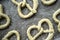 Raw pretzels with coarse salt are placed on a metal tray and are ready for baking in the oven. Traditional food. Oktoberfest. Top