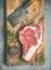 Raw prime beef meat dry-aged steak rib-eye and chopping knife