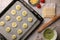 Raw puff pastry and ingredients on tiled table