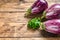 Raw purple Aubergine or eggplant. wooden background. Top view. Copy space