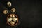 raw quail eggs in a clay bowl and on a black stone plate on a textured dark concrete surface. moody artistic mockup with copy