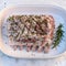 Raw rack of pork with spices in the baking dish. Top view