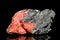 Raw red baryte on mother rock, mineral stone in front of black background