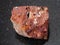 raw red bauxite stone on dark background