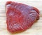 Raw Red TUNA steak on wooden chopping board. Tonno rosso used for tartarre, sushi, sashimi.