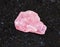 Raw Rhodochrosite crystal on black