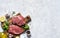 Raw Ribeye beef steak cooking with ingredients: salt, pepper, lemon. Top view with copy space