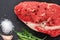 Raw ribeye beef steak with spices, Black Angus meat with seasonings, gray stone background, top view