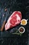 Raw ribeye steak marbled meat with salt, olive oil, rosemary and