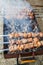 raw roasted marinated meat barbecue shish kebab shashlik on steel metal skewers lying grill fire brazier