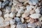 Raw rocks and minerals as natural stones background with crushed and rough material at a rough coast or rocky beach