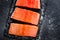 Raw salmon filet on dark slate background, wild atlantic fish, space for text