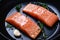 Raw Salmon Filets in Frying Pan with Thyme and Garlic Ready to Cook