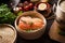 Raw salmon fillet in bamboo steamer on dark rustic kitchen table with ingredients and tools. Healthy eating and cooking. Dieting