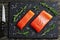 Raw salmon fillet with fresh rosemary,. salt on slate plate on old dark wooden table with knife, view from above, close-up