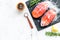 Raw salmon fish on black plates for cooking steaks on marble restaurant kitchen background top view space for text