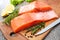 Raw salmon fish fillet with fresh herbs