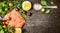 Raw salmon fish fillet with spoon of salt, fresh herbs and spices on rustic wooden background, top view, banner