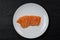 Raw salmon sashimi white plate on black background