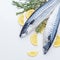 Raw sardines on a table with ice and lemon. View from above