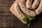 Raw sausages prepared for roasting and cooking ingredients, basil and spices on a  brown wooden table. top view