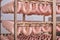 Raw sausages on racks in storage room at meat processing factory