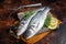 Raw Sea Bass, Branzino fish with thyme and lemon. Dark background. Top view