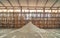 Raw sea salt heap inside traditional local wooden storage barn. Nature material in salt industry factory
