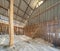 Raw sea salt heap inside traditional local wooden storage barn. Nature material in salt industry factory