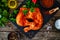 Raw seasoned chicken thighs on stony cutting board on wooden table