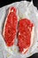 Raw seasoned sirloin prime british steaks on paper