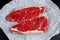 Raw seasoned sirloin prime british steaks on paper