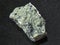 raw serpentinite stone on dark background