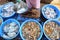 Raw shrimp, squid and fish at fish market in Asia, close-up. Local seafood market in India