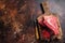 Raw sirloin beef cut, Silverside steak on a wooden board. Dark background. Top view. Copy space