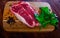 Raw sliced marbled beef meat with parsley and condiments
