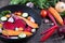 Raw sliced vegetables for roasting, on a baking tray. Assortment of vegetables from the garden.