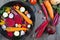 Raw sliced vegetables for roasting, on a baking tray. Assortment of vegetables from the garden.