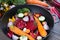 Raw sliced vegetables for roasting, on a baking tray. Assortment of vegetables from the garden.