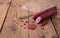 Raw smoked sausage lies on an old wooden table with spices, herbs and spices