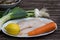 Raw sole on a plate with lemon, sage, carrot, fish, fresh, wooden table, table