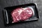 Raw steak in an airtight packaging