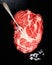 Raw steak from marble beef, salt, vintage meat fork on a black background