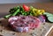 Raw steak with vegetables ready to be cooked