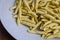 Raw strozzapreti, specialties from northern Italy, fresh twisted pasta that cooks very quickly and is suitable for chunky sauces