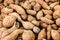 Raw sweet potatoes display at fresh market stall