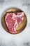 Raw T-bone porterhouse beef meat Steak on golden metalic plate. Gray background. Top view