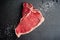 Raw T-Bone Steak with Kosher Salt and Black Peppercorns